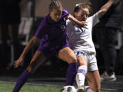 Ridgefield senior Paytn Barnette, right, and Columbia River sophomore Avah Eslinger fight for the ball Tuesday, Nov. 2, 2021, during the Spudders' 3-0 win against Columbia River in a GSHL District 4 2A playoff game at Columbia River High School.