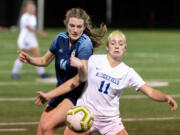 Hockinson's Molly Ramanchock and Ridgefield's Claire Jones fight for the ball in the 2A District Girls Soccer Championship on Thursday, Nov. 4, 2021, at District Stadium in Battle Ground.