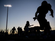 Camas football players warm up Friday, Nov. 5, 2021, before the Papermakers’ game against Mount Rainier at Doc Harris Stadium.