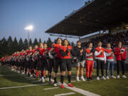 Camas High School football players stand during the national anthem Friday, Nov. 5, 2021, before the Papermakers’ playoff game against Mount Rainier at Doc Harris Stadium.