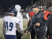 Camas head football coach Jack Hathaway, right, shakes hands Friday, Nov. 5, 2021, after the Papermakers’ 57-20 win against Mount Rainier in a 4A GSHL playoff game at Doc Harris Stadium.