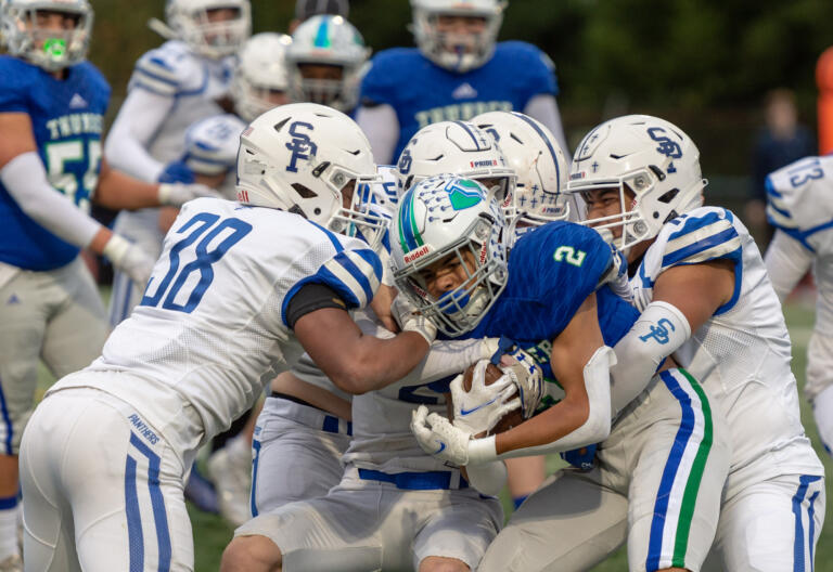 Seattle Prep players swarm Mountain View's Akili Kamau in a 3A State preliminary game on Saturday, Nov. 6, 2021, at McKenzie Stadium. Seattle Prep defeated Mountain View 38-27 to end the Thunder season.