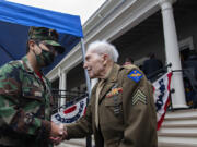 Kyle Borneman, left, 14, of the Lewis and Clark Young Marines greets World War II veteran Wilbert Kalmbach of Camas, 94, following the Veterans Day Ceremony at the Fort Vancouver Artillery Barracks on Thursday afternoon, Nov. 11, 2021. Kalmbach served his country in the Phillipines during WWII.