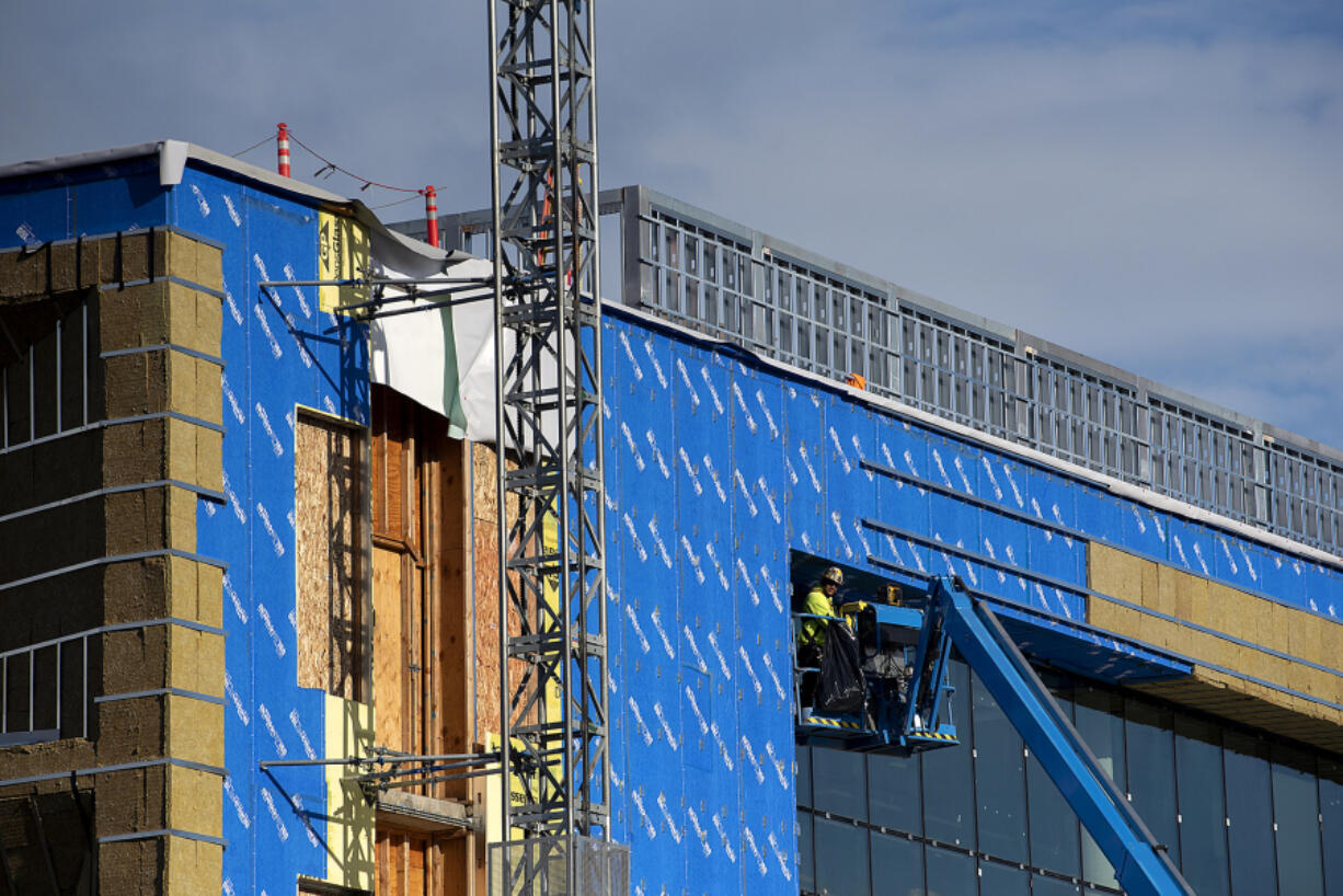 A worker lends a hand to the construction of VITA Elementary School at 1111 Fort Vancouver Way. The school is set to open in fall 2022.