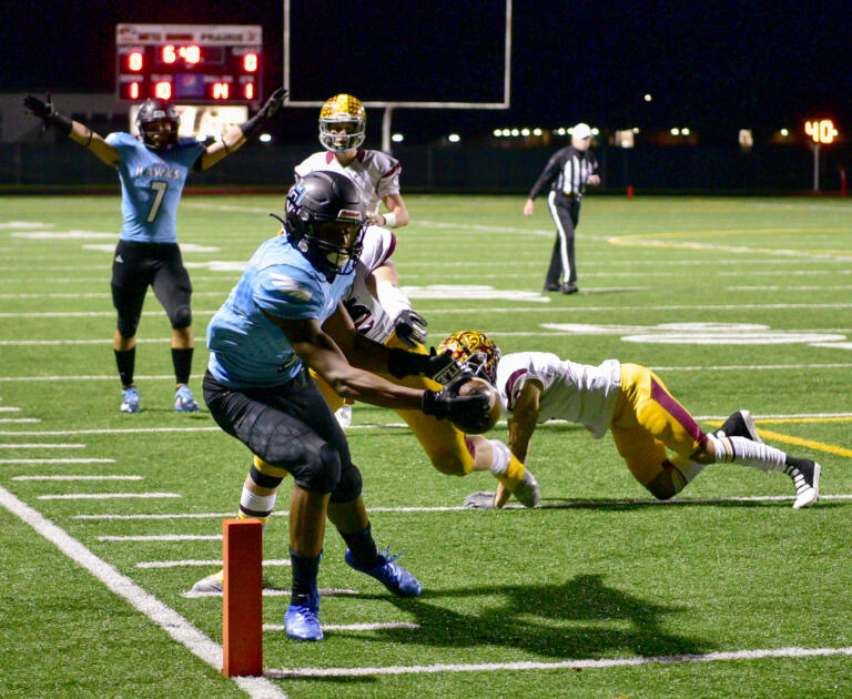 Hockinson senior Kenyon Johnson, left, stretches to score a touchdown Friday, Nov. 12, 2021, during the Hawks’ 38-28 loss to Enumclaw at Battle Ground High School.