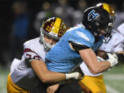 Hockinson junior Tyler Litle, right, runs downfield while being tackled by Enumclaw senior Mataala Tagaloa Friday, Nov. 12, 2021, during the Hawks’ 38-28 loss to Enumclaw at Battle Ground High School.