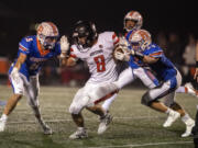 Ridgefield's Ty Snider (5) defends against Orting's Aiden Herd (8) while assisted by teammate Davis Pankow (33) in the second quarter At Ridgefield High School on Saturday night, Nov. 13, 2021.