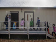 Substitute teacher Alison Davies, left, holds the door while leading second-graders back to their classroom at Union Ridge Elementary School  on Nov. 17.