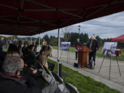 Roben White, at podium, a member of the Washington State University Vancouver's Native American Community Advisory Board, gives a blessing during the ground breaking ceremony Thursday morning. White is a descendant of the Cheyenne and Lakota tribes.