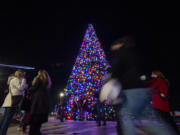 People mill around a 54-foot Christmas tree on Wednesday evening at a tree lighting event at ilani on the Cowlitz Indian Reservation.