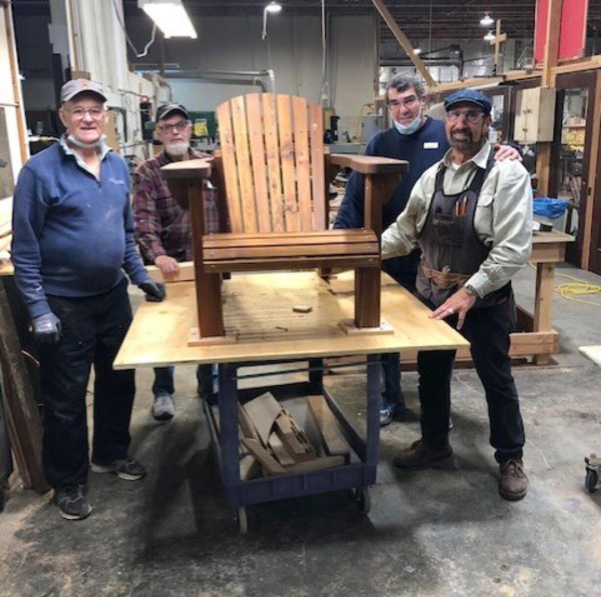 Jeff Chandler, Ken Leffel, Jim Pearson and Doug Corso build Adirondack chairs to raise funds for Friends of the Carpenter.