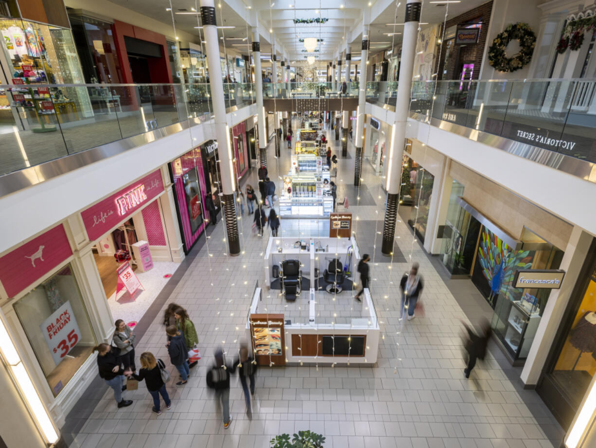 Black Friday shoppers walk around Friday.