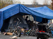 Residents clear out their belongings from a homeless encampment in the North Image neighborhood Monday afternoon to comply with Vancouver's camping ordinance. According to the rule, there can't be unrestricted camping within 1,200 feet of Safe Stay Communities.