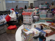 Ruth Cunningham helps assemble more than 1,000 gift bags at CDM Caregiving Services on Tuesday afternoon. The bags will be distributed to Clark County caregivers at the second annual Caregiver Christmas on Dec. 7.