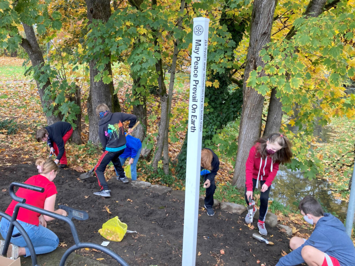 BATTLE GROUND: Local teens plant tulips throughout the community as a part of Red Ribbon Week's annual drug prevention program.