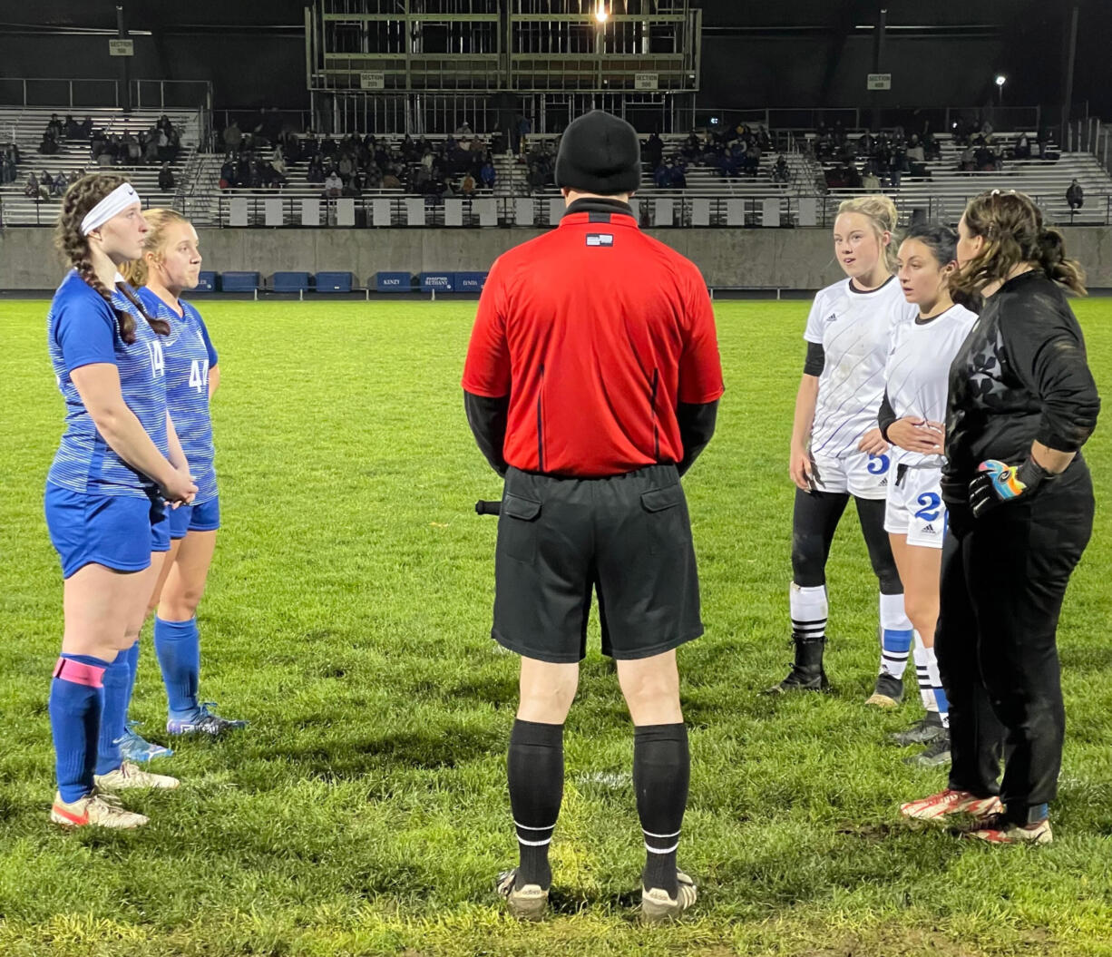 Players from La Center, left, and Elma meet with the referee before the start of overtime in a Class 1A District 4 semifinal match on Thursday at La Center High.