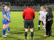 Players from La Center, left, and Elma meet with the referee before the start of overtime in a Class 1A District 4 semifinal match on Thursday at La Center High.