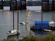 The Alert, an abandoned former Coast Guard vessel, sits on the bottom of the Columbia River downstream from the Interstate 5 Bridge in Portland after it sank Sunday evening.