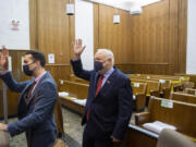 Attorney Evan Bariault, left, and plaintiff Don Benton thank the court staff as they leave the courtroom after hearing the favorable verdict in their lawsuit against Clark County.