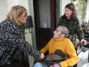 Rabbi Douglas Goldhamer is greeted by colleague and former student Alison Brown, left, as his wife Peggy Bagley assists the rabbi at home Oct. 26 in Evanston, Ill. (John J.