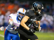 Hockinson Hawks Andre Northrup (1) gains against Ridgefield Spudders Connor Delamarter (45) in the 2A Greater St. Helens League season opener for both teams at Hockinson High School on Friday, Sept. 17, 2021. (Randy L.