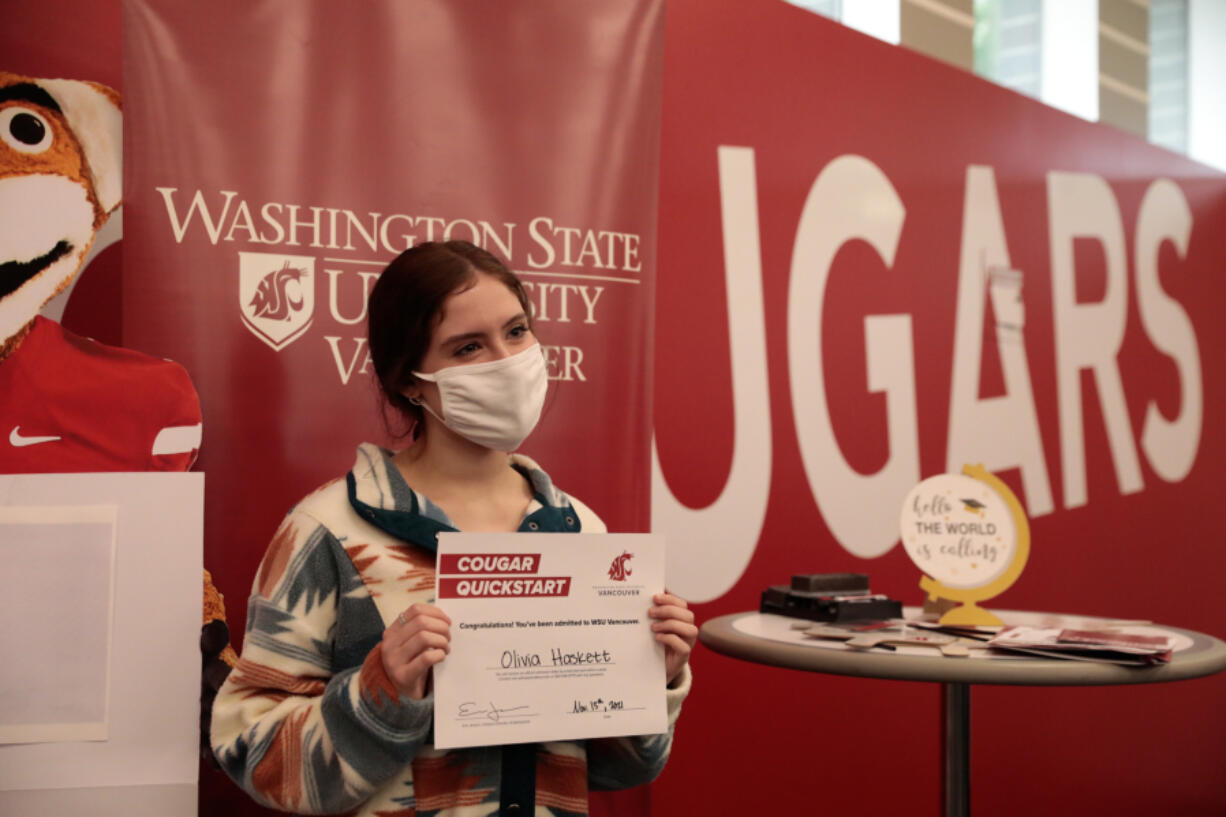 Mountain View High School senior Olivia Haskett poses for a photo with her Cougar Quickstart certificate for same-day admission from Washington State University Vancouver during fall preview day at the Salmon Creek campus on Saturday.