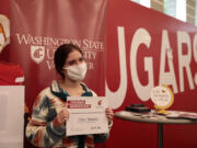 Mountain View High School senior Olivia Haskett poses for a photo with her Cougar Quickstart certificate for same-day admission from Washington State University Vancouver during fall preview day at the Salmon Creek campus on Saturday.