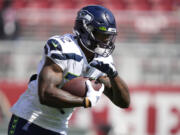 Seattle Seahawks running back Chris Carson warms up before an NFL football game against the San Francisco 49ers in Santa Clara, Calif., Sunday, Oct. 3, 2021.