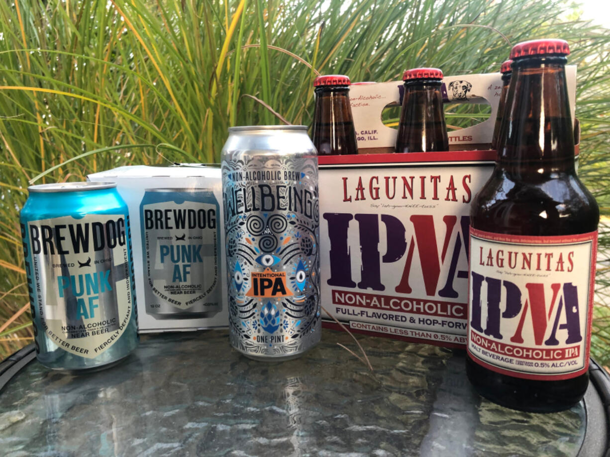 Non-alcoholic beers, from left, BrewDog's Punk AF IPA; WellBeing's Intentional IPA; and Lagunitas' IPNA.