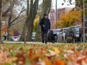 Christopher Hsieh walks his dog Petunia at Clark Park in Philadelphia. Sidewalks and proximity to parks are two amenities that pet owners seek when they decide where to live.