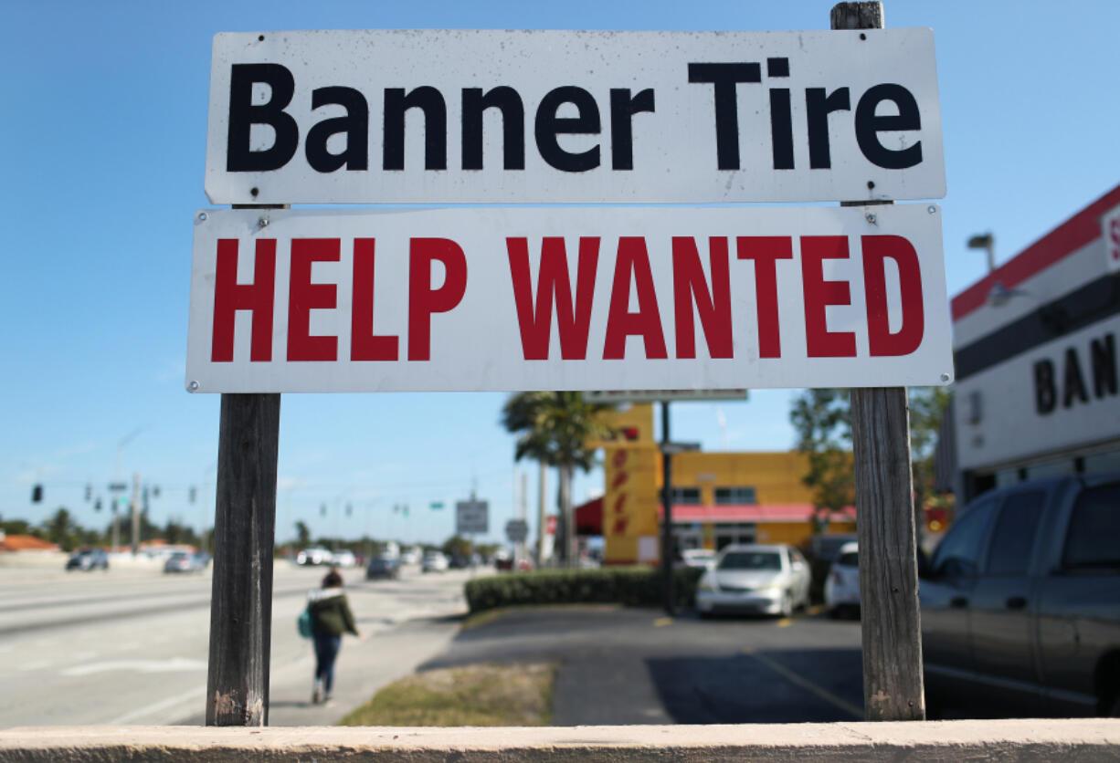 A "Help Wanted" sign is posted in front of a business on February 4, 2021 in Miami.