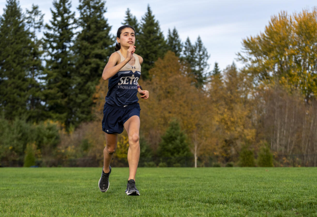 Seton Catholic sophomore Alexis Leone dashes across the grass Wednesday, Nov. 17, 2021, at Seton Catholic High School. Leone is the All-Region girls cross country runner of the year.