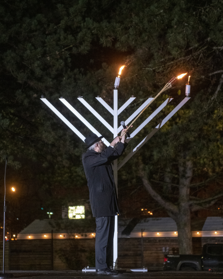 Rabbi Shmulik Greenberg lights the Menorah to celebrate the first day of Hanukkah at a Drive-In Grand Menorah Lighting in a parking lot across the street from the Clark County Historical Museum on Thursday night, Dec. 10, 2020.