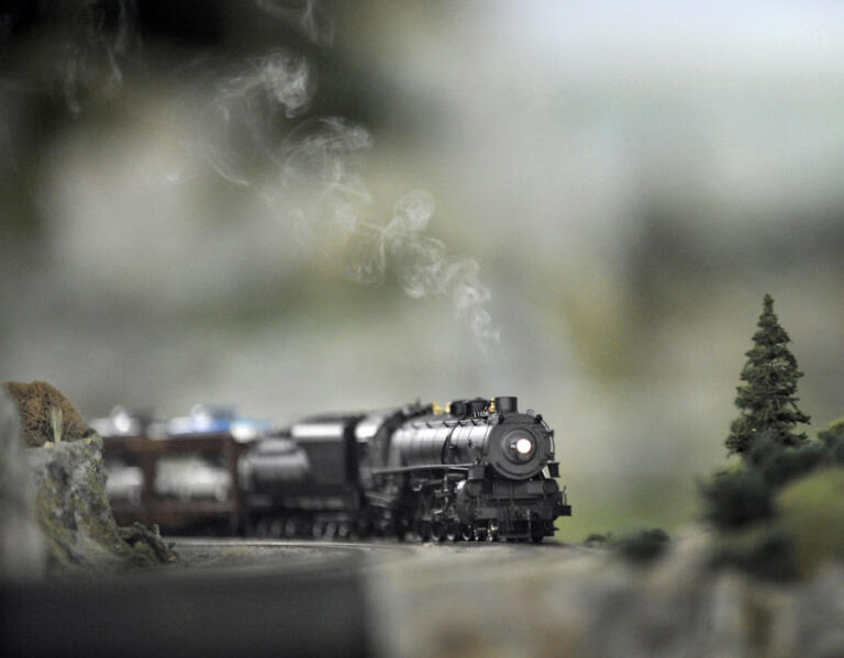 A HO scale model train engine owned by Hank Schmitten belches smoke.