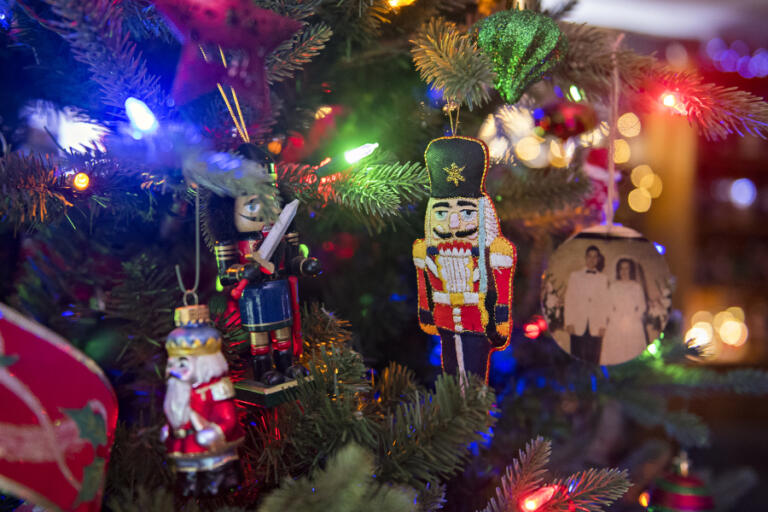 Colorful nutcracker-themed ornaments hang on the Christmas tree of Joanne Pearson next to a photo from her wedding at her Vancouver home Tuesday morning, December 15, 2020.