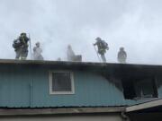 Vancouver firefighters battled a second-story apartment fire Monday afternoon in the Harney Heights neighborhood.