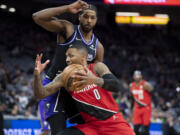 Portland Trail Blazers guard Damian Lillard (0) drives past Sacramento Kings center Tristan Thompson (13) during the first quarter of an NBA basketball game in Sacramento, Calif., Wednesday, Nov. 24, 2021.