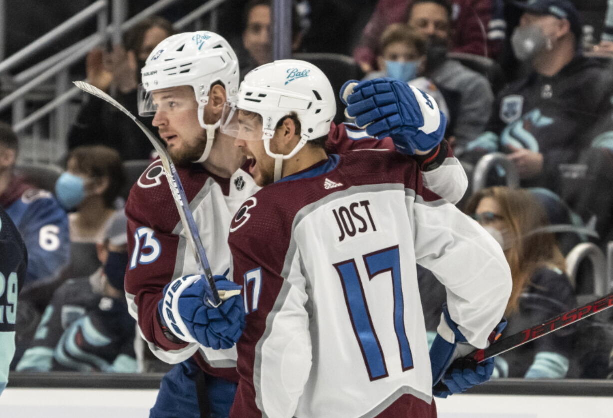 Colorado Avalanche right wing Valeri Nichushkin (13) and center Tyson Jost celebrate a short-handed goal by Nichushkin during the first period of an NHL hockey game against the Seattle Kraken, Friday, Nov. 19, 2021, in Seattle.