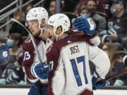 Colorado Avalanche right wing Valeri Nichushkin (13) and center Tyson Jost celebrate a short-handed goal by Nichushkin during the first period of an NHL hockey game against the Seattle Kraken, Friday, Nov. 19, 2021, in Seattle.