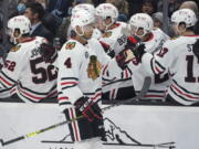 Chicago Blackhawks defenseman Seth Jones (4) greets teammates after he scored a goal against the Seattle Kraken during the first period of an NHL hockey game, Wednesday, Nov. 17, 2021, in Seattle. (AP Photo/Ted S.