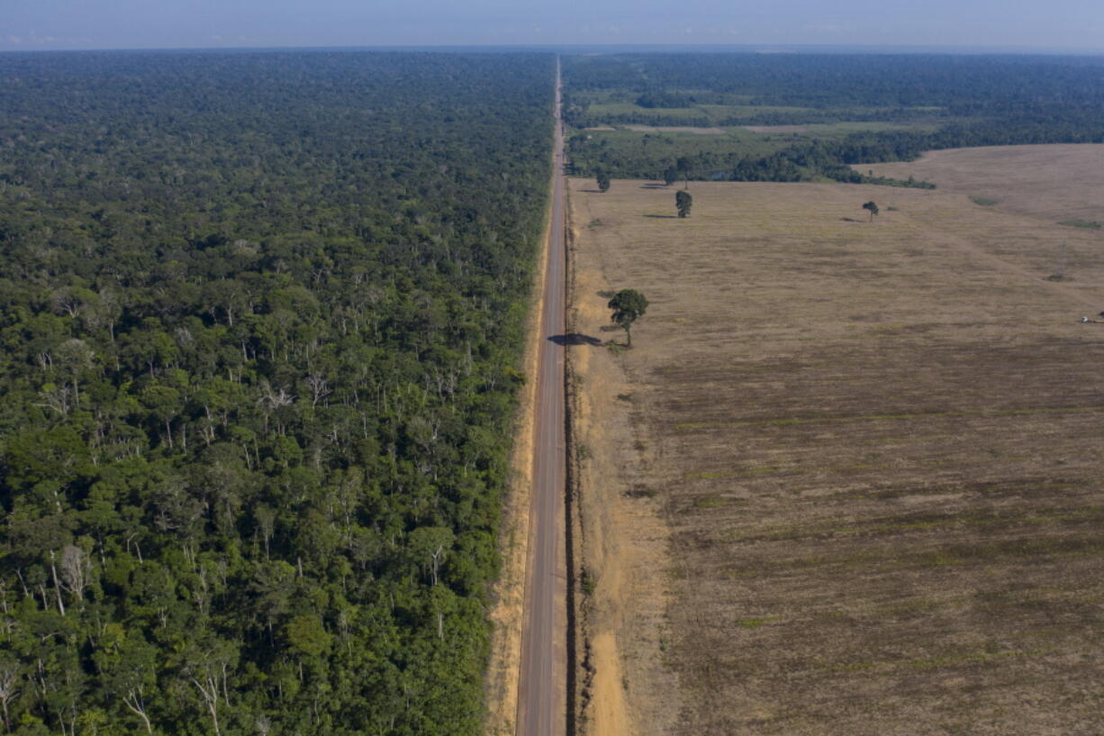 FILE - In this Nov. 25, 2019 file photo, highway BR-163 stretches between the Tapajos National Forest, left, and a soy field in Belterra, Para state, Brazil. The number of deforestation alerts in the Brazilian Amazon rose for the second straight month in October 2021, compared to 2020, ending a streak of encouraging data at a moment when the government has promised to curb illegal logging.