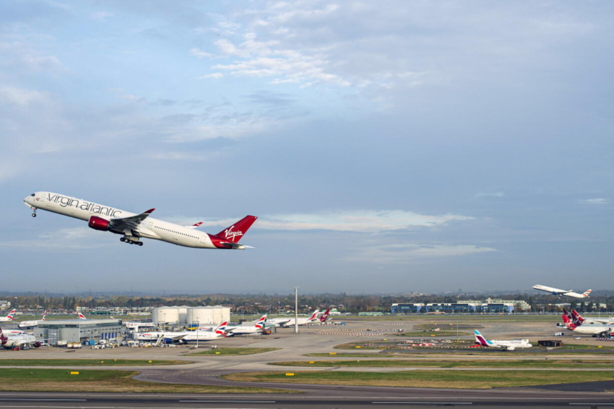 Virgin Atlantic flight VS3, front, and British Airways flight BA001 perform a synchronised departure on parallel runways at London Heathrow Airport, Monday, Nov. 8, 2021 heading for New York JFK to celebrate the reopening of the transatlantic travel corridor, more than 600 days since the US travel ban was introduced due to the Covid-19 pandemic.