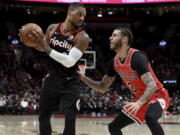 Portland Trail Blazers guard Damian Lillard, left, looks to drive to the basket past Chicago Bulls guard Lonzo Ball during the first half of an NBA basketball game in Portland, Ore., Wednesday, Nov. 17, 2021.