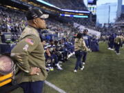 Seattle Seahawks defensive coordinator Ken Norton Jr., left, stands near the bench late in the second half against the Arizona Cardinals on Sunday. (Ted S.