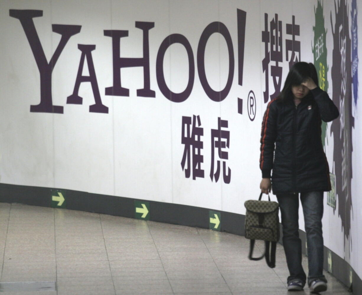 FILE - A woman walks past a Yahoo billboard in a Beijing subway in this March 17, 2006. Yahoo Inc. on Tuesday, Nov.