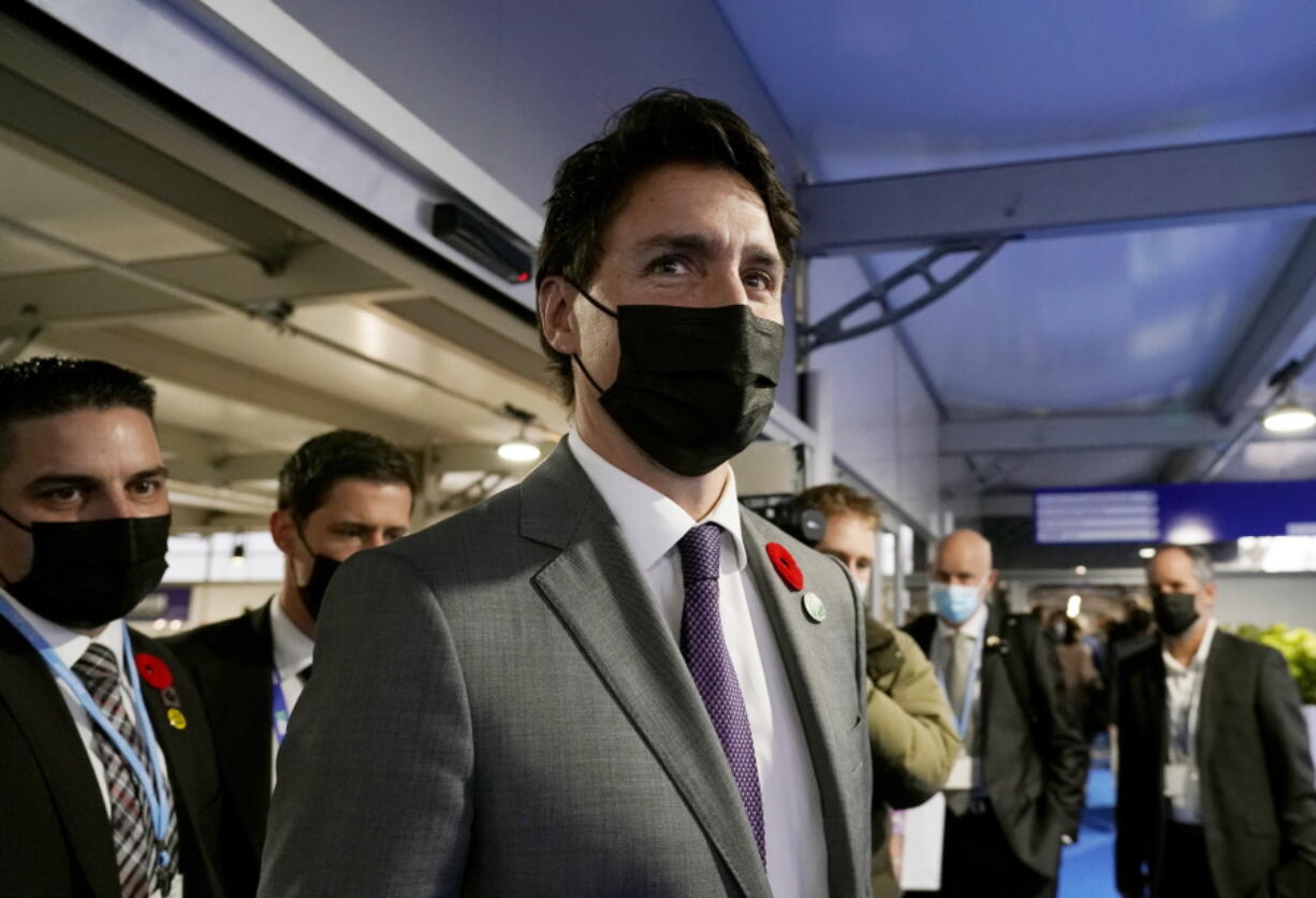 Canada's Prime Minister Justin Trudeau walks down a corridor inside the venue of the COP26 U.N. Climate Summit in Glasgow, Scotland, Tuesday, Nov. 2, 2021. The U.N. climate summit in Glasgow gathers leaders from around the world, in Scotland's biggest city, to lay out their vision for addressing the common challenge of global warming.