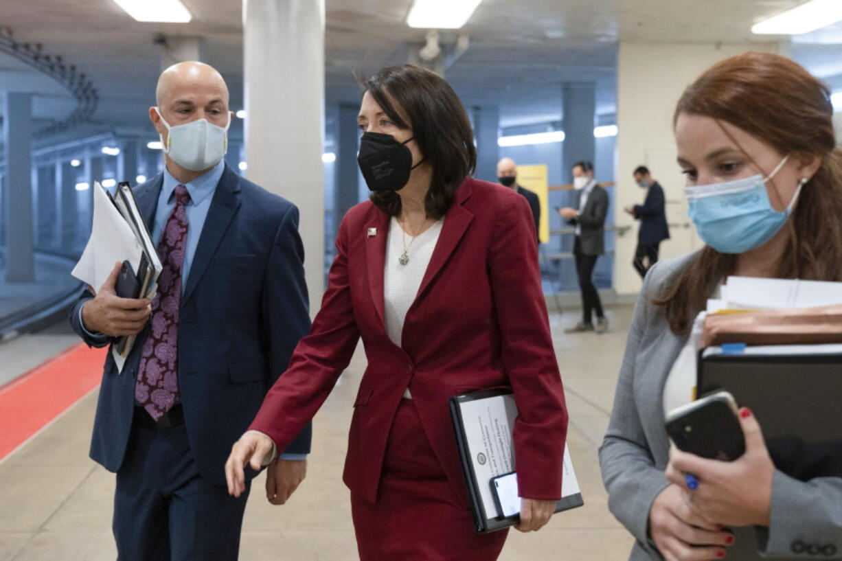 Sen. Maria Cantwell, D-Wash., center, walks to a vote, Tuesday, Oct. 19, 2021, on Capitol Hill in Washington.