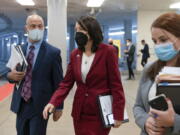 Sen. Maria Cantwell, D-Wash., center, walks to a vote, Tuesday, Oct. 19, 2021, on Capitol Hill in Washington.