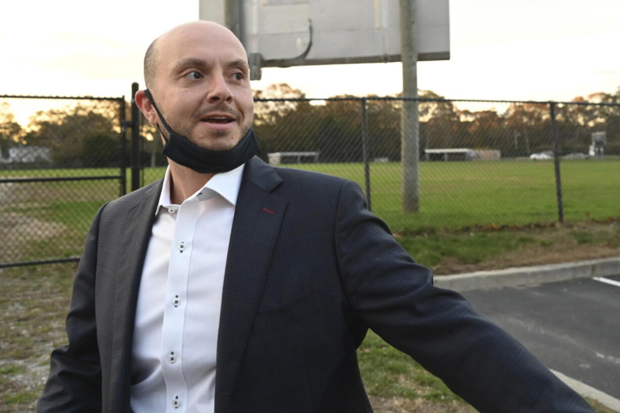 FILE -- Assemblyman Andrew Garbarino arrives at Bayport-Blue Point High School to vote, in Bayport, N.Y., Nov. 3, 2020. A Long Island man has been arrested for making a death threat against Garbarino who voted for $1.2-trillion infrastructure package, police said, Wednesday, Nov. 11, 2021.