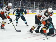 Anaheim Ducks center Ryan Getzlaf (15) and Seattle Kraken left wing Marcus Johansson (90) compete for the puck during the first period of an NHL hockey game, Thursday, Nov. 11, 2021, in Seattle as Ducks right wing Troy Terry, left, and Kraken center Calle Jarnkrok watch. (AP Photo/Ted S.